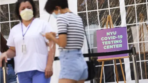 EPA Medical personnel direct students arriving to a Covid-19 testing tent set up at New York University in New York City