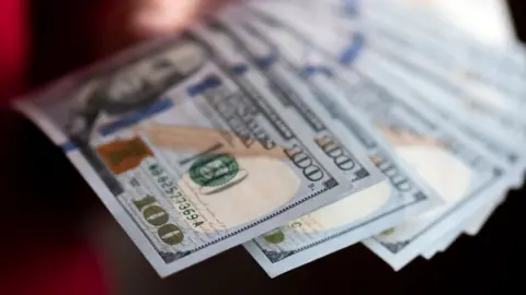 LightRocket via Getty Images One hundred US dollar banknotes are seen on display