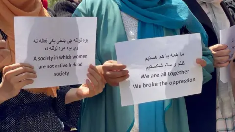 AFP "We are all together, we broke the oppression" - signs at protest in Kabul
