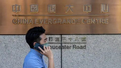EPA A man walks past the China Evergrande Centre in Hong Kong.