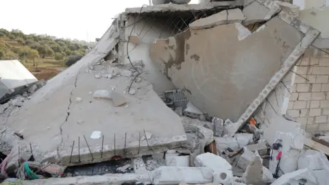 EPA A damaged building is seen after a US special forces raid in Atmeh, Syria (3 February 2022)