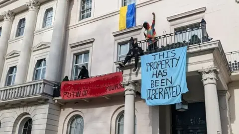 Met Police watch protesters occupying a building in Belgravia