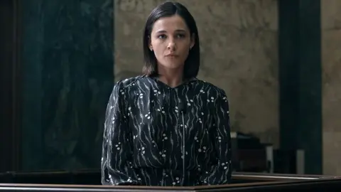 Netflix Naomi Scott's character standing in a court room