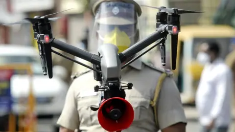 Getty Images A drone being used by police to monitor activities of people
