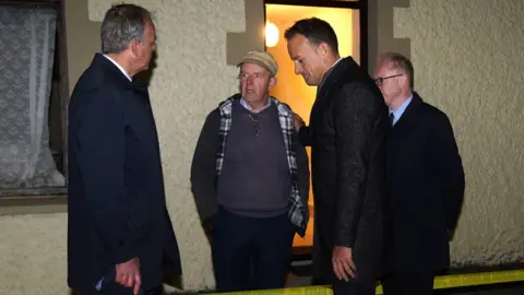 PA Media Leo Varadkar speaks to residents of Creeslough
