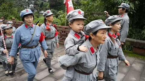 CNS Chinese tourists dressed up in the Red Army's uniforms while visiting a "red tourism" site in Guizhou Province in 2021.