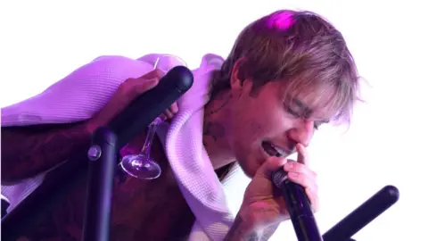 Getty Images Justin Bieber singing into microphone