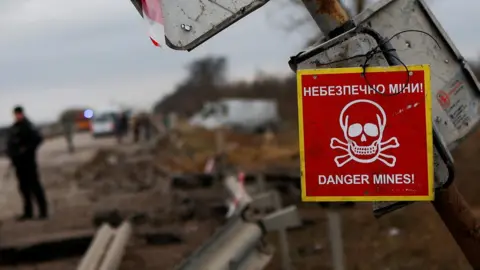 Reuters A mine warning sign hangs from a pole by the main road to Kherson