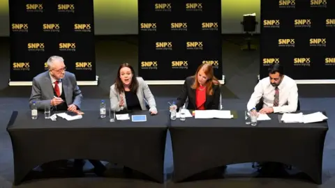 PA Media Scottish National Party President Mike Russell, Kate Forbes, Ash Regan and Humza Yousaf taking part in the first SNP leadership hustings in Cumbernauld