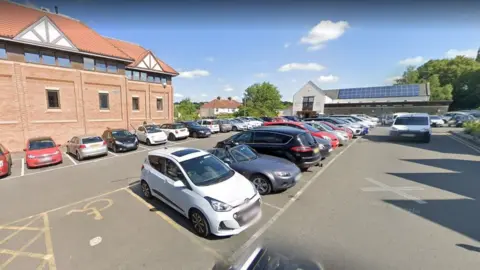 Google Westbury Hill car park in Westbury-on-Trym, with the GP surgery at the rear