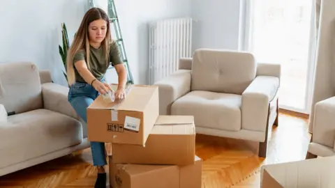 Getty Images Woman unpacking boxes