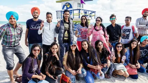 Getty Images Asian students in group portrait on a beach in Miami, Florida
