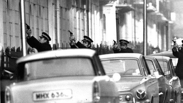 PA Police officers during the Balcombe Street siege in London in 1975