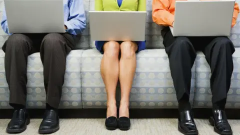 Getty Images Men and a woman with laptops