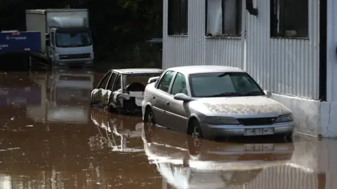 PA Cars submerged in water as the River Dennet in Londonderry burst its banks