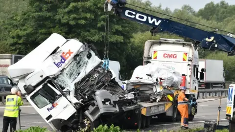 LNP A lorry involved in the collision is towed away