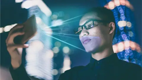 Getty Images man's face being scanned by smartphone