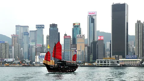 Laurent Fievet/Getty One of the last remaining Chinese junks sails past Hong Kong (Credit: Laurent Fievet/Getty)
