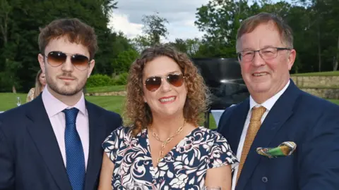 Getty Benji, Hannah and Colin Ingram-Moore smiling at the camera