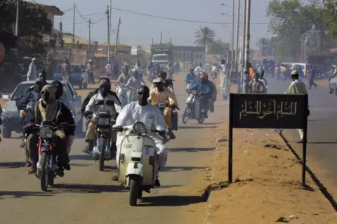AFP Men on motorbikes