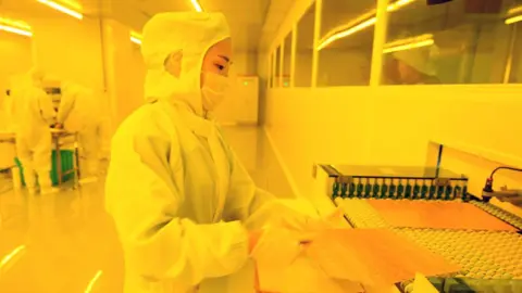 Getty Images Chinese worker in mobile factory