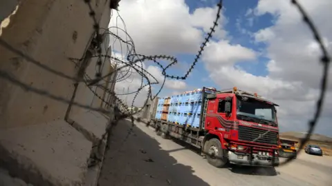 Reuters A lorry carrying goods arrives at the Kerem Shalom cargo crossing in the southern Gaza Strip town of Rafah (15 August 2018)