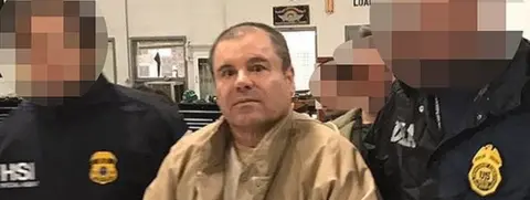 AFP/Getty Images This handout picture released by the Mexican interior ministry shows Joaquín "El Chapo" Guzmán (centre) escorted by Mexican police officers before his extradition to the US. Photo: January 2017