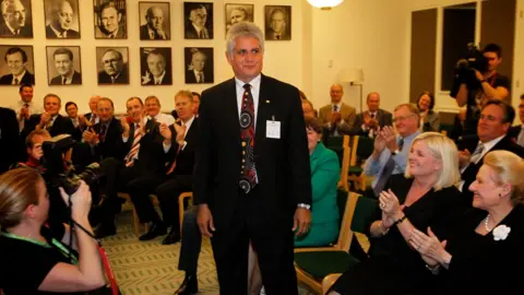Getty Images/Fairfax Media Ken Wyatt stands up in the Liberal party caucus room as other party members applaud