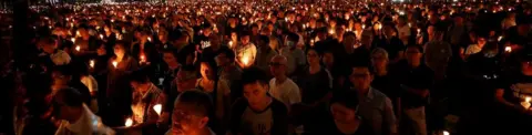 Reuters People attend a candlelight vigil at Victoria Park in Hong Kong