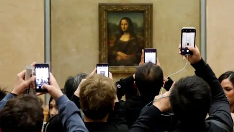 Reuters File image from May 2019 of visitors taking photographs of the Mona Lisa