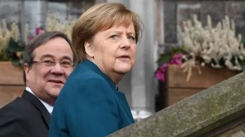 Getty Images German Chancellor Angela Merkel (R) and the State Premier of North Rhine-Westphalia Armin Laschet arrive to attend the signature ceremony of a French-German friendship treaty, on January 22, 2019