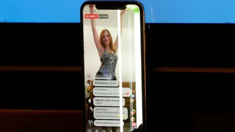 Reuters Nermine Sfar's performance being shown on a mobile phone