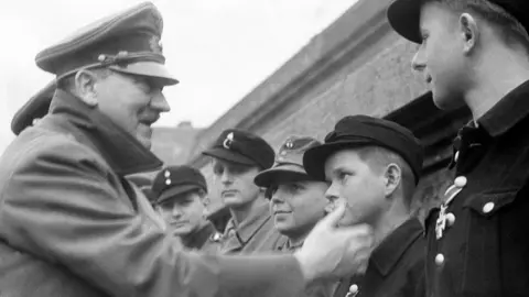 Getty Images Adolf Hitler congratulates a 12-year-old German soldier