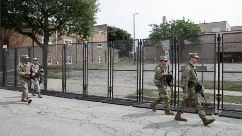 Reuters Members of the Wisconsin National Guard arrive at Kenosha County Public Safety Building on 31 August