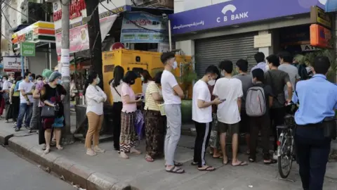 EPA Myanmar people line up in front of an ATM of a closed bank in Yangon, Myanmar, 01 February 2021