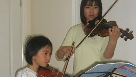 Northamptonshire Police Alice and Xing playing violin