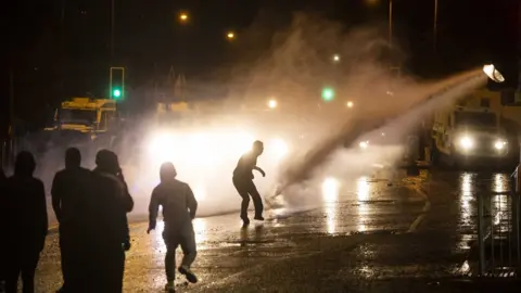 EPA Nationalist youths clashing with Police on the Springfield Road in west Belfast, in Northern Ireland