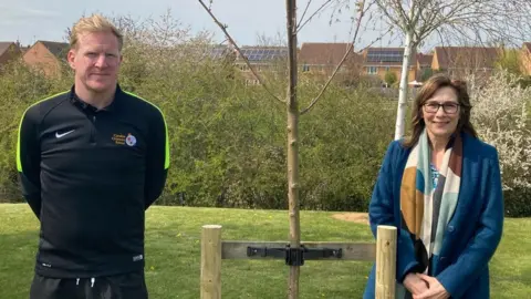 Joe Rich and Katherine Patterson in front of Alice Ding's memorial at Caroline Chisholm School