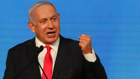 Reuters Benjamin Netanyahu gestures as he delivers a speech to supporters following the announcement of exit polls in Israel's general election in Jerusalem (24 March 2021)