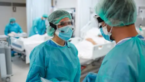 Getty Images Two NHS worker in PPE equipment