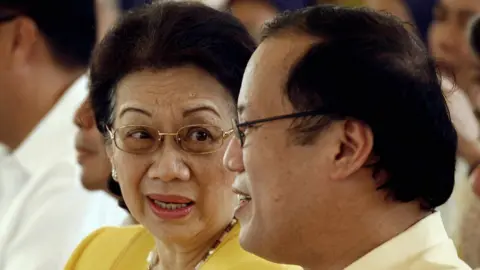 AFP Former Philippine president Corazon Aquino (L), talks with her son Senator Noynoy during a memorial service at Manila Memorial Park in suburban Manila, 21 August 2007, marking the 24th anniversary of assassination of former opposition leader senator Benigno Aquino .