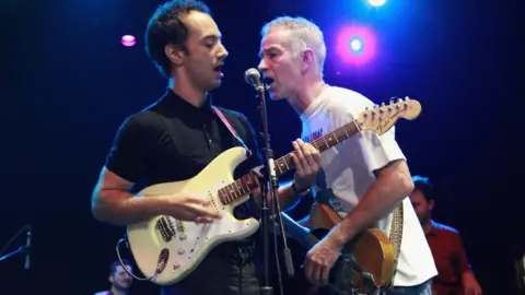 Getty Images Albert Hammond Jr of The Strokes and tennis player John McEnroe perform at Petty Fest NYC in 2012