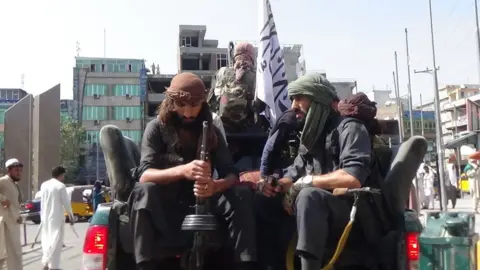 Getty Images Taliban soldiers patrol the streets of Jalalabad on 17 April