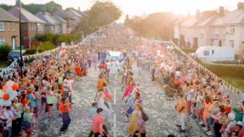 Amazon The street party scene on Deerlands Avenue