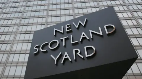 Reuters The rotating triangular sign is seen outside New Scotland Yard in central London