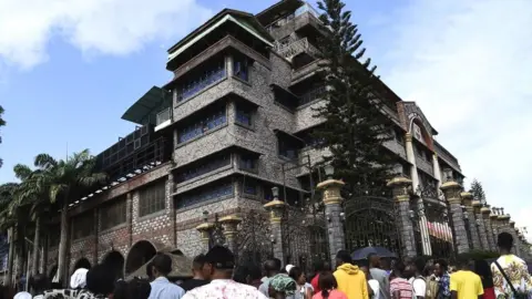 AFP Residents and church members gather at the main gate of The Synagogue Church of All Nations headquarters to mourn the death of TB Joshua in Lagos, Nigeria - 6 June 2021