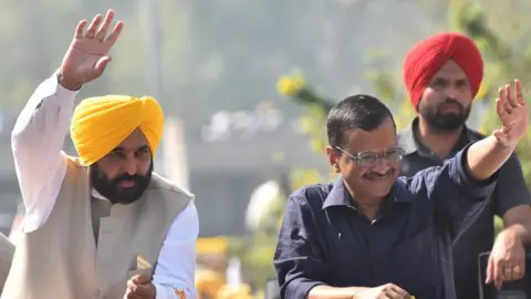 Getty Images Aam Aadmi Party (AAP) national convener Arvind Kejriwal with Punjab chief minister-designate Bhagwant Mann during a road show to thank voters for the partys victory in Punjab assembly election on March 13, 2022 in Amritsar, India.