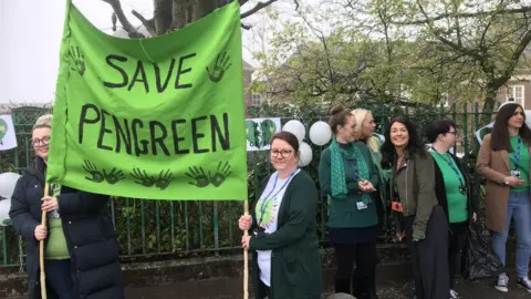 Stuart Ratcliffe/BBC Pen Green nursery protest, parents and people holding a banner