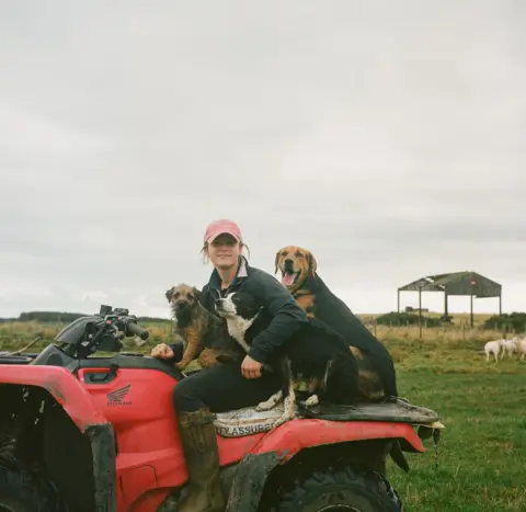Joanne Coates Hannah, a shepherd, with her three working dogs near Chatton in Northumberland