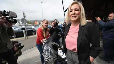 Getty/Charles McQuillan Sinn Fein northern leader Michelle O'Neill meets members of the public as she canvasses ahead of the Northern Ireland Assembly elections at Kennedy shopping centre on May 3, 2022 in Belfast, Northern Ireland. Recent polls suggest that Sinn Fein may become the largest party in Northern Ireland following the elections with Michelle O'Neill becoming First Minister elect, the first time Sinn Fein would be designated as First Minister in a power sharing government. (Photo by Charles McQuillan/Getty Images)